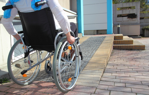 Person in wheelchair using a ramp